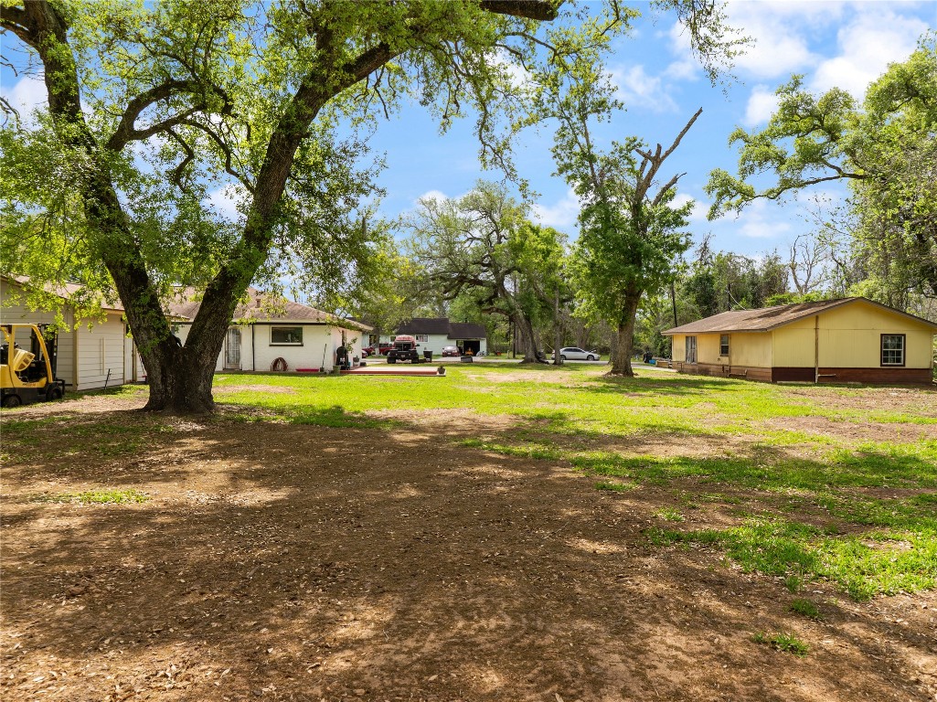 496 James Street Clute, TX 77531 - Photo 5 of 45 a view of a house with swimming pool and a big yard