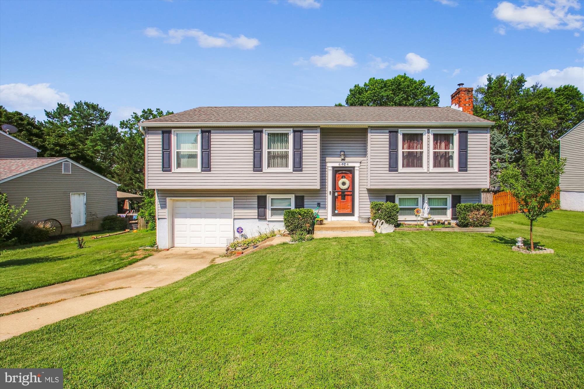 a front view of a house with a yard porch and sitting area