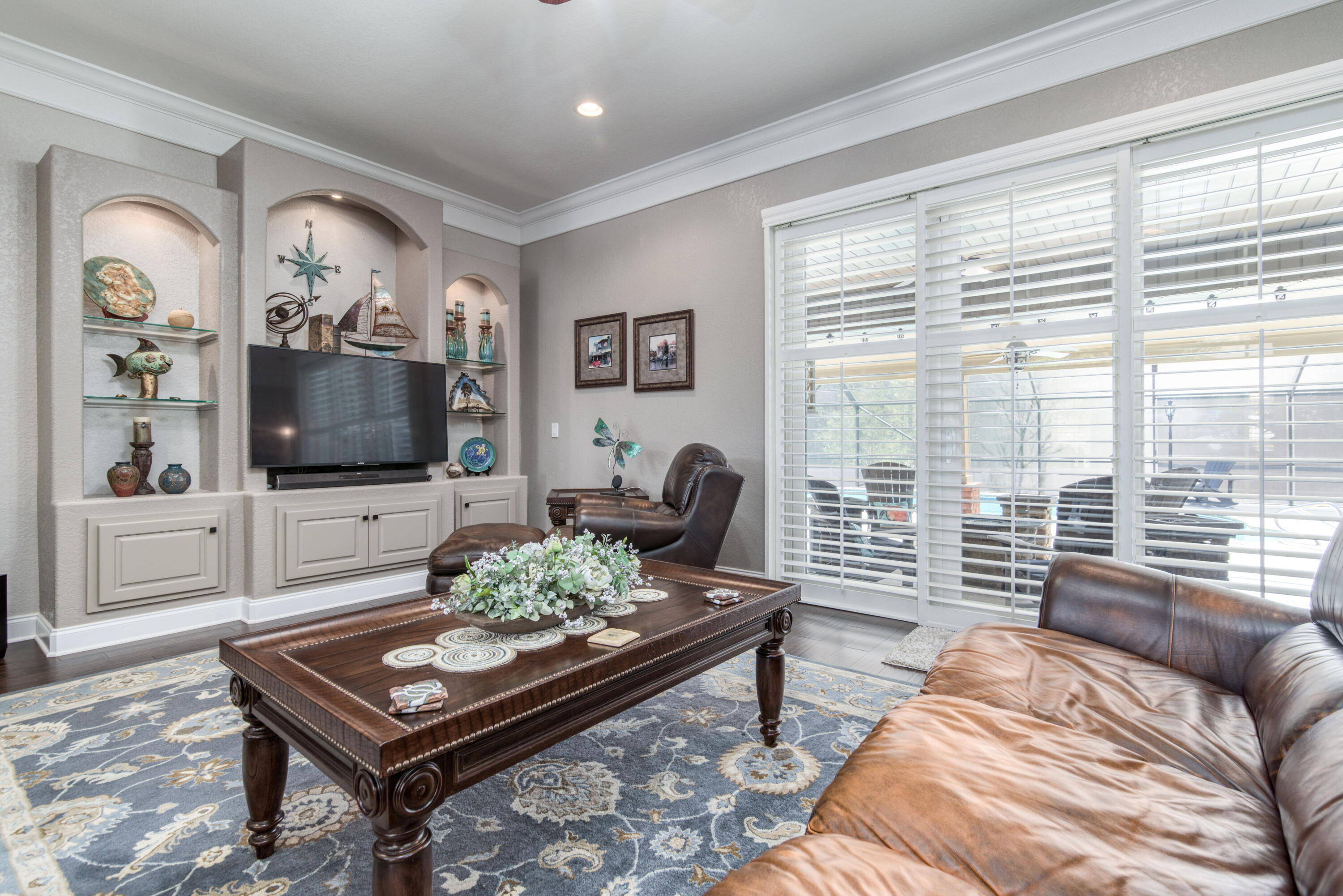 4563 Pfitzer Circle Crestview, FL 32536 - Photo 13 of 79 a living room with furniture a flat screen tv and a large window