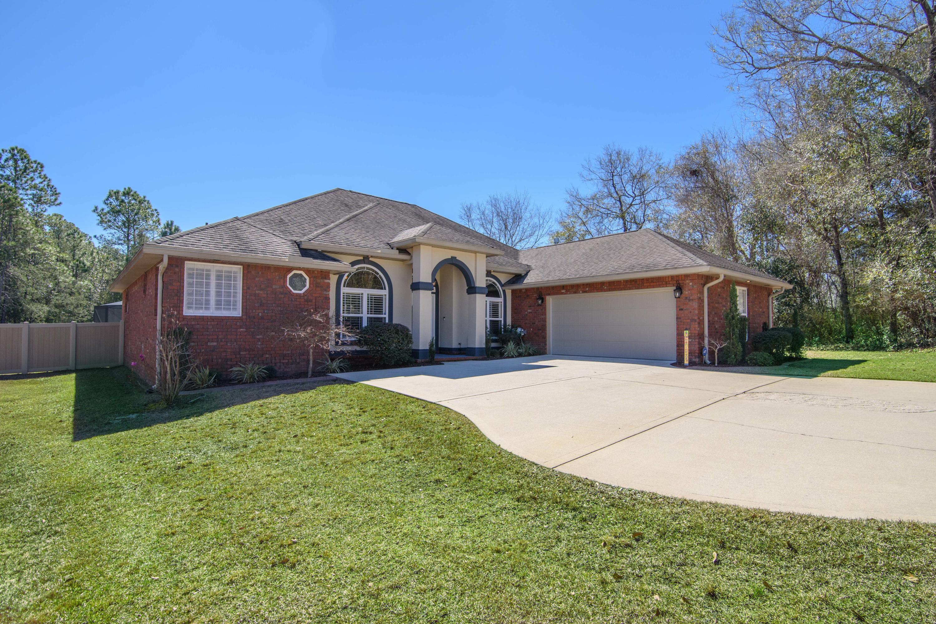 4563 Pfitzer Circle Crestview, FL 32536 - Photo 2 of 79 a front view of a house with garden