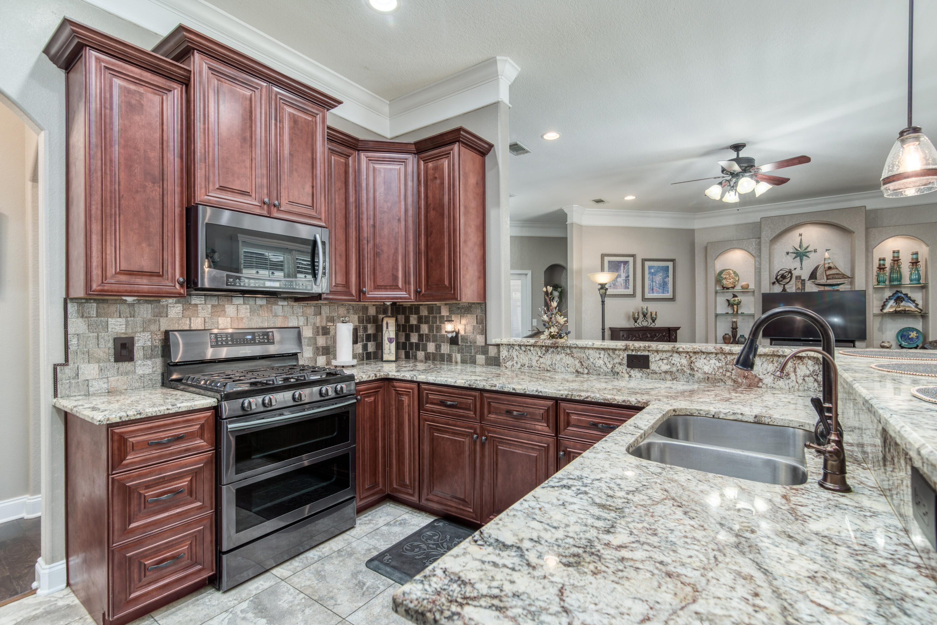 4563 Pfitzer Circle Crestview, FL 32536 - Photo 21 of 79 a kitchen with stainless steel appliances granite countertop a stove and a sink