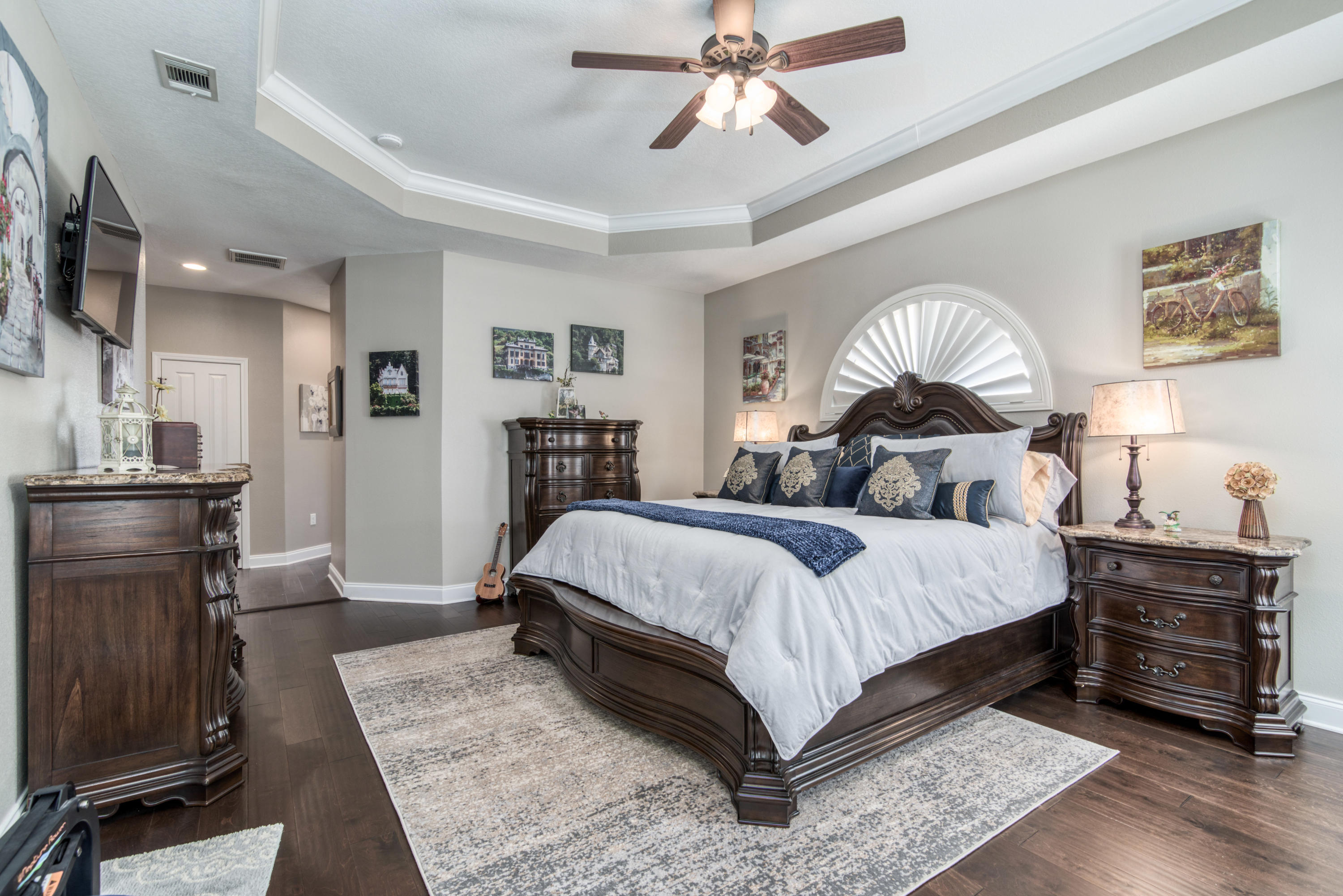 4563 Pfitzer Circle Crestview, FL 32536 - Photo 27 of 79 a bedroom with a bed and a chandelier