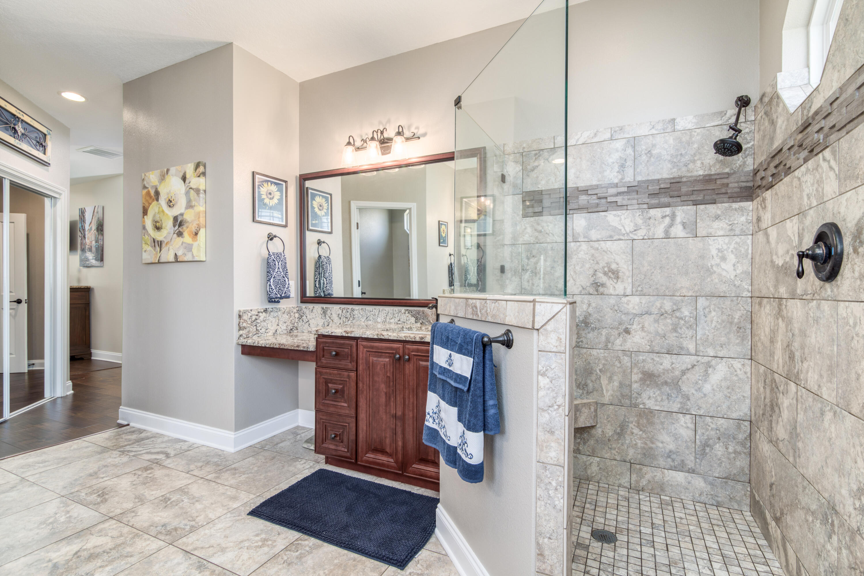 4563 Pfitzer Circle Crestview, FL 32536 - Photo 34 of 79 a bathroom with a granite countertop shower a sink and a mirror