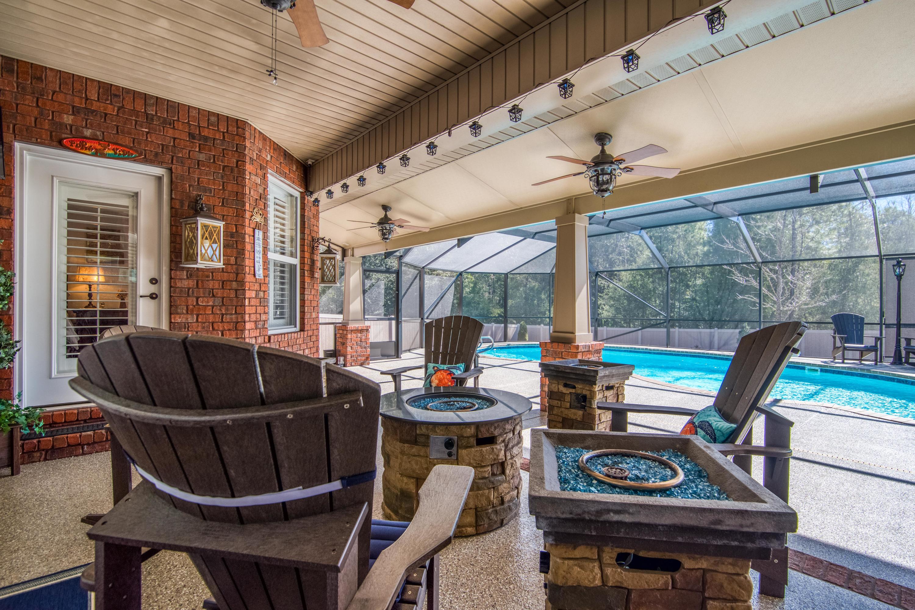4563 Pfitzer Circle Crestview, FL 32536 - Photo 45 of 79 a living room with furniture a large window and a table