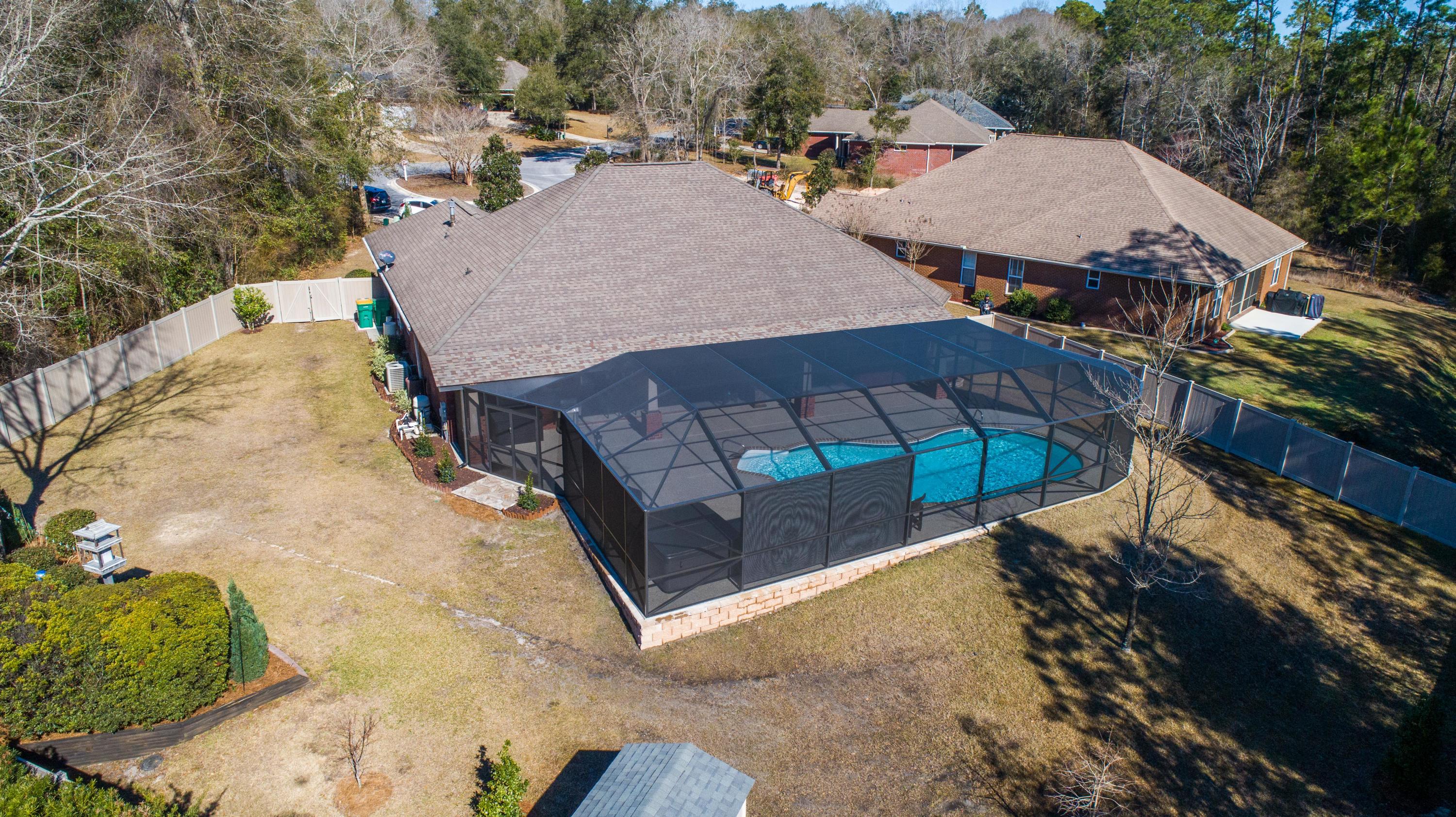 4563 Pfitzer Circle Crestview, FL 32536 - Photo 74 of 79 a view of a patio with table and chairs under an umbrella
