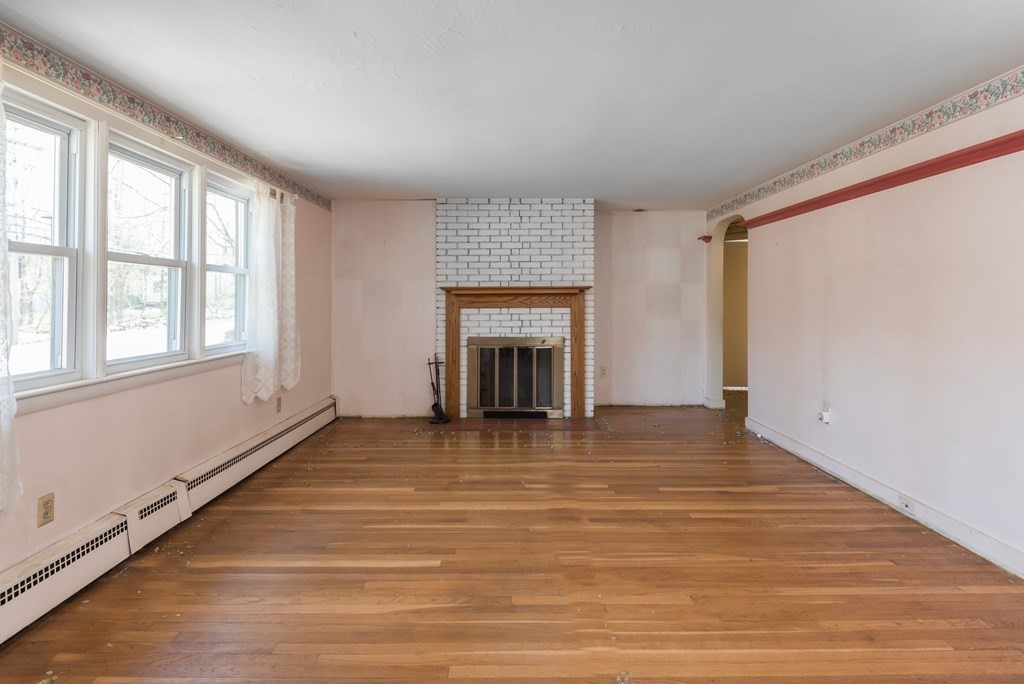 409 Bay Road Easton, MA 02375 - Photo 12 of 26 a view of an empty room with a window and fireplace