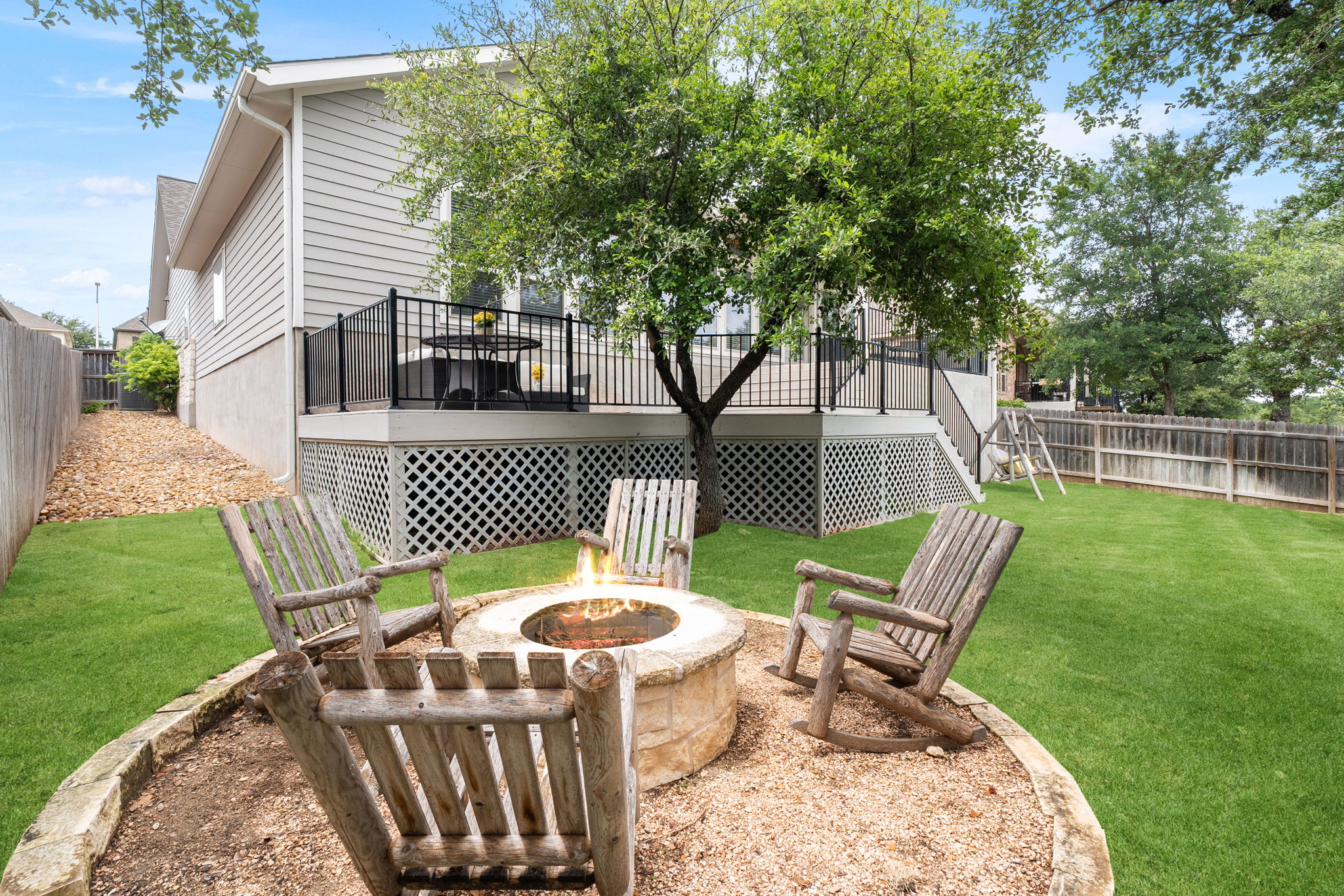 1908 Woolsey Way Leander, TX 78641 - Photo 25 of 36 An inviting fire pit area and a spacious deck provide perfect outdoor gathering spots in this fenced yard.