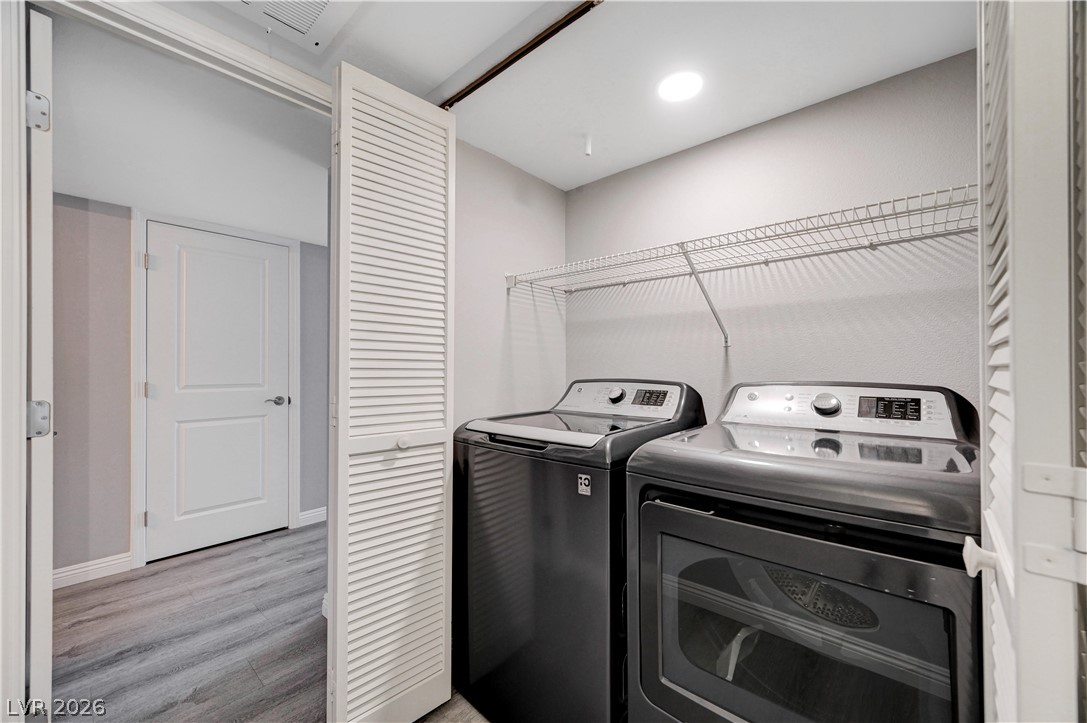 3425 East Russell Road, Unit 223 Las Vegas, NV 89120 - Photo 33 of 47 A well-appointed laundry room features a washer and dryer, with convenient shelving and louvered bifold doors.