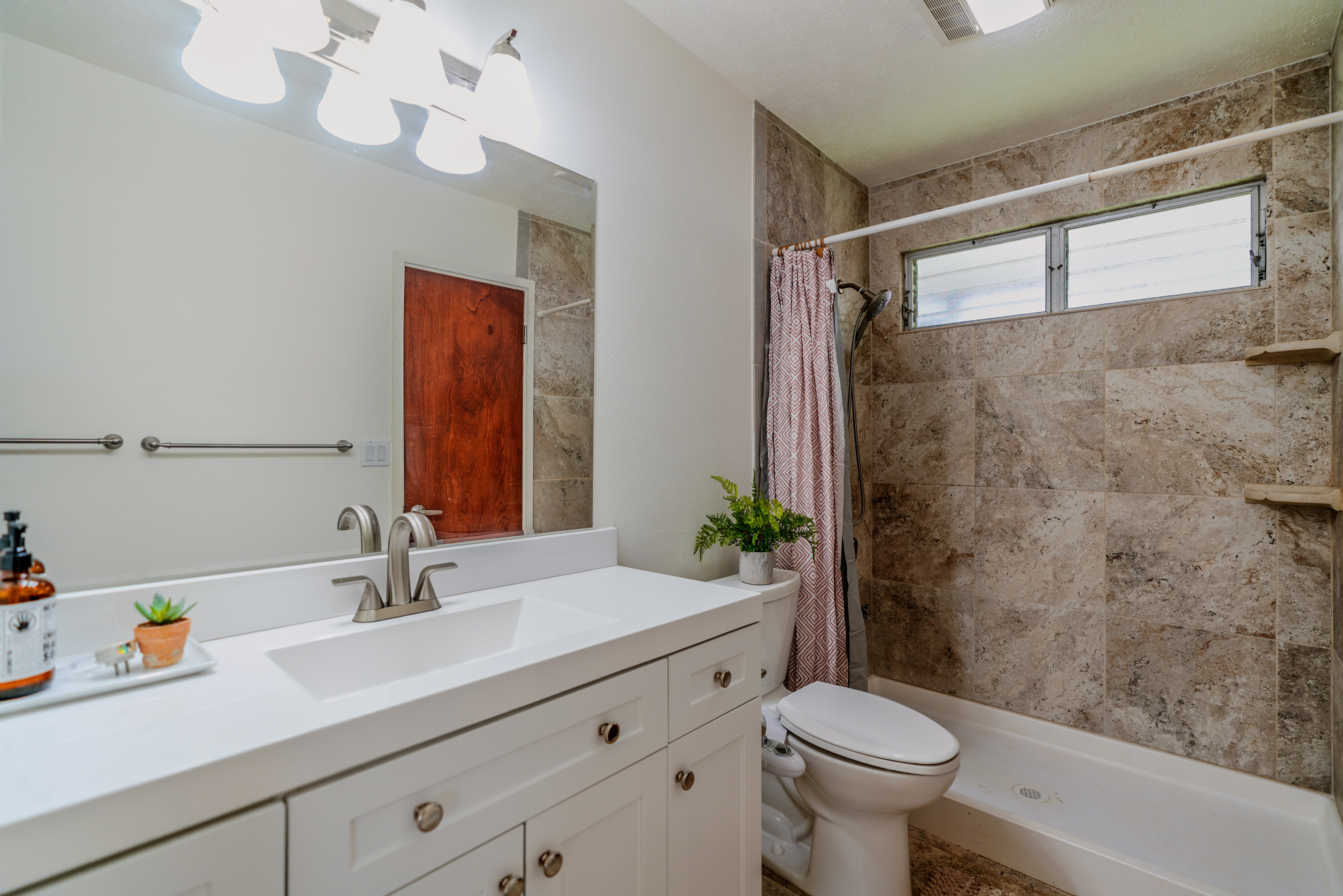 316 A Makani Road, Unit A Kapaa, HI 96746 - Photo 18 of 29 a bathroom with a sink a toilet and shower