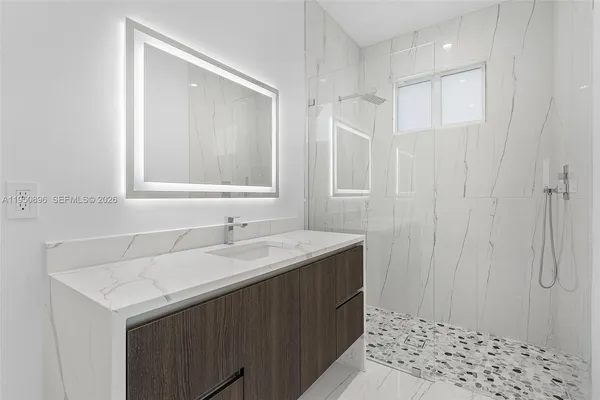 a bathroom with a sink and a mirror