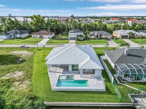 an aerial view of a house with big yard