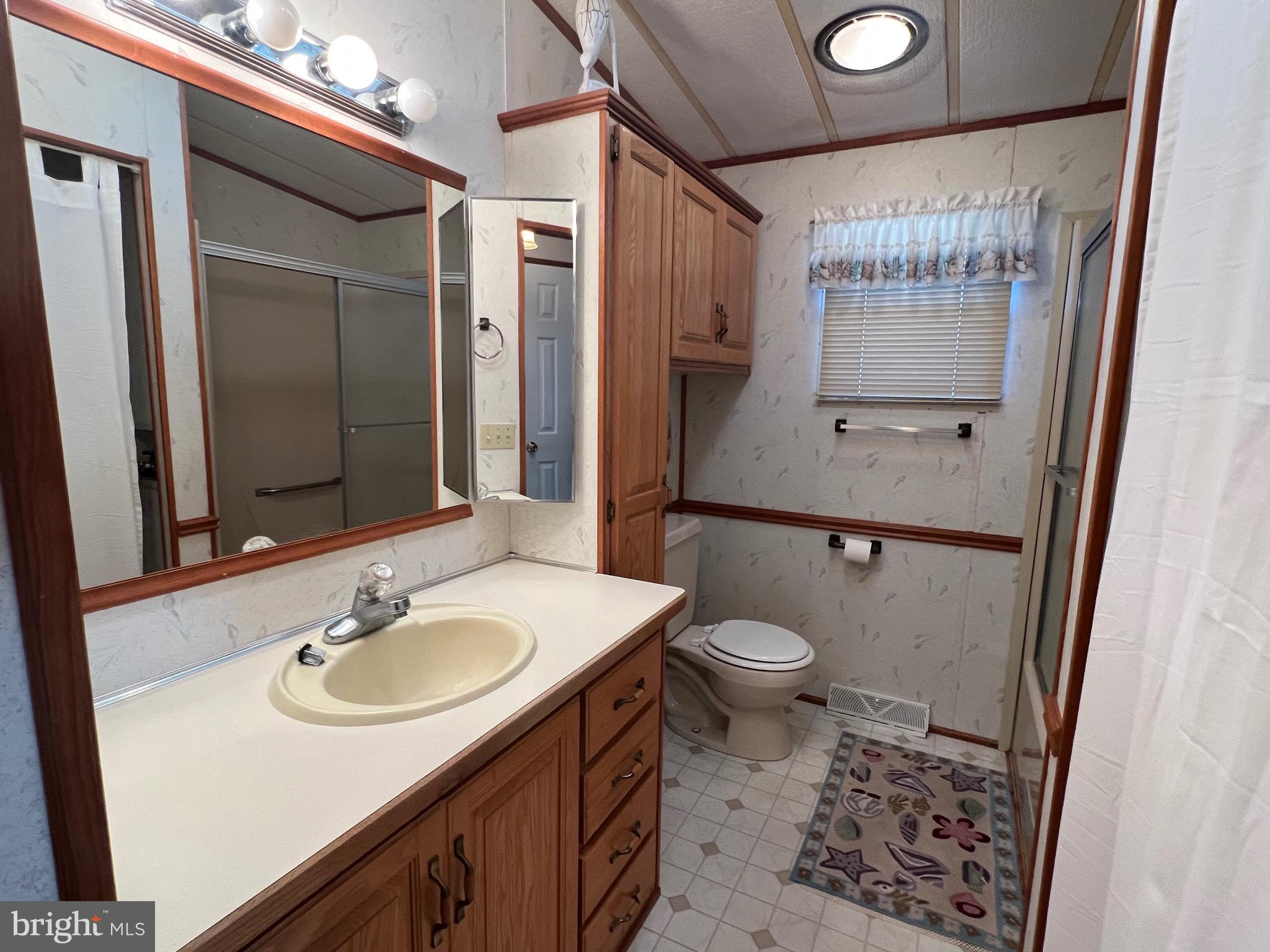 12412 Windlass Way Berlin, MD 21811 - Photo 15 of 105 a bathroom with a sink toilet and shower