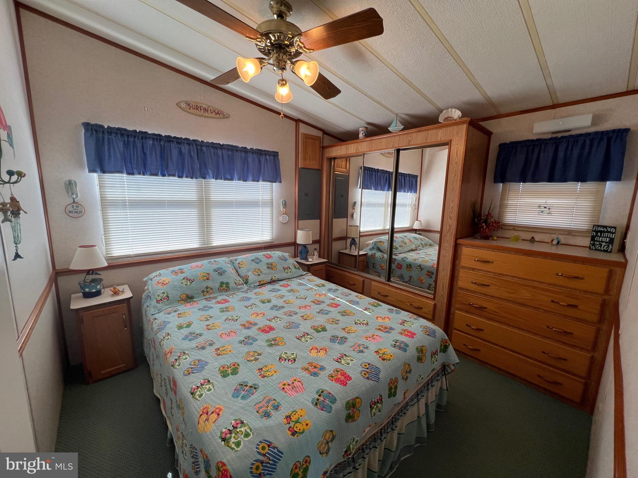 12412 Windlass Way Berlin, MD 21811 - Photo 17 of 105 a bedroom with a bed next to a window with a flat screen tv
