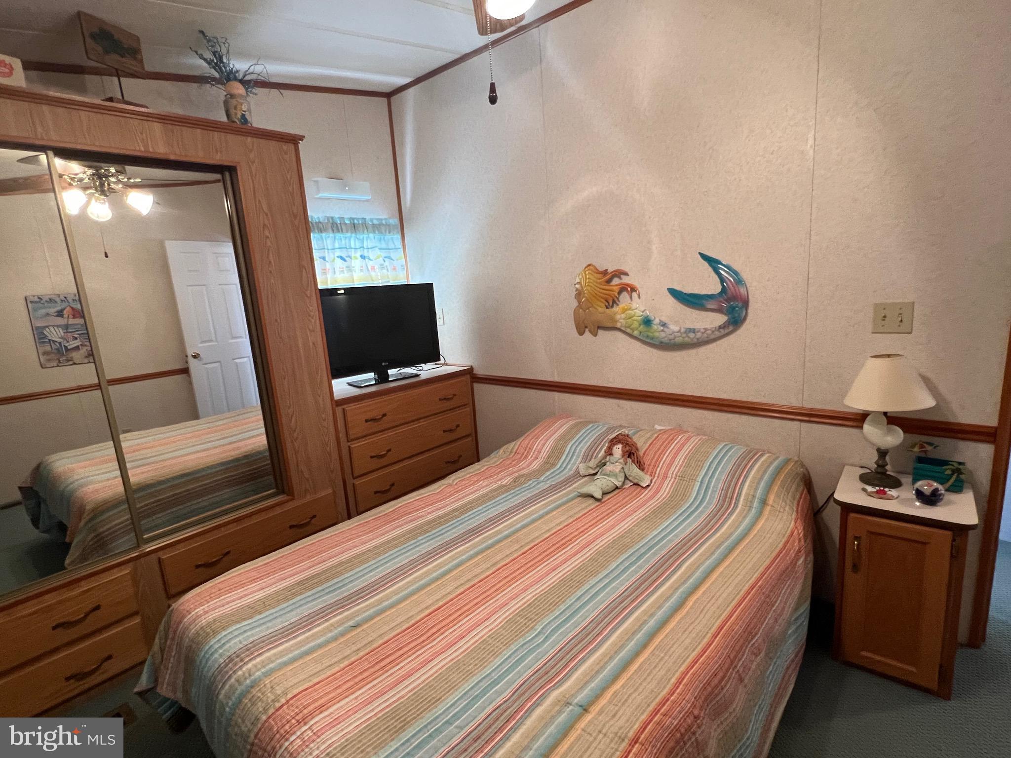 12412 Windlass Way Berlin, MD 21811 - Photo 19 of 105 a bedroom with bed and a flat screen tv