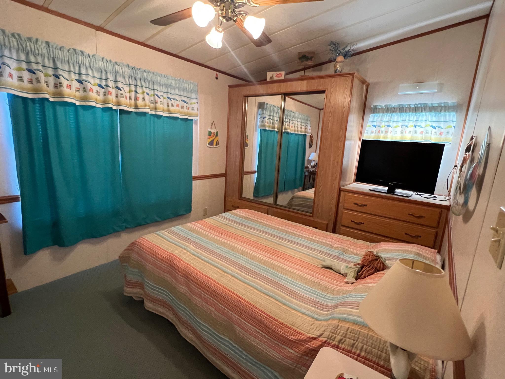 12412 Windlass Way Berlin, MD 21811 - Photo 20 of 105 a bedroom with a bed and a flat screen tv