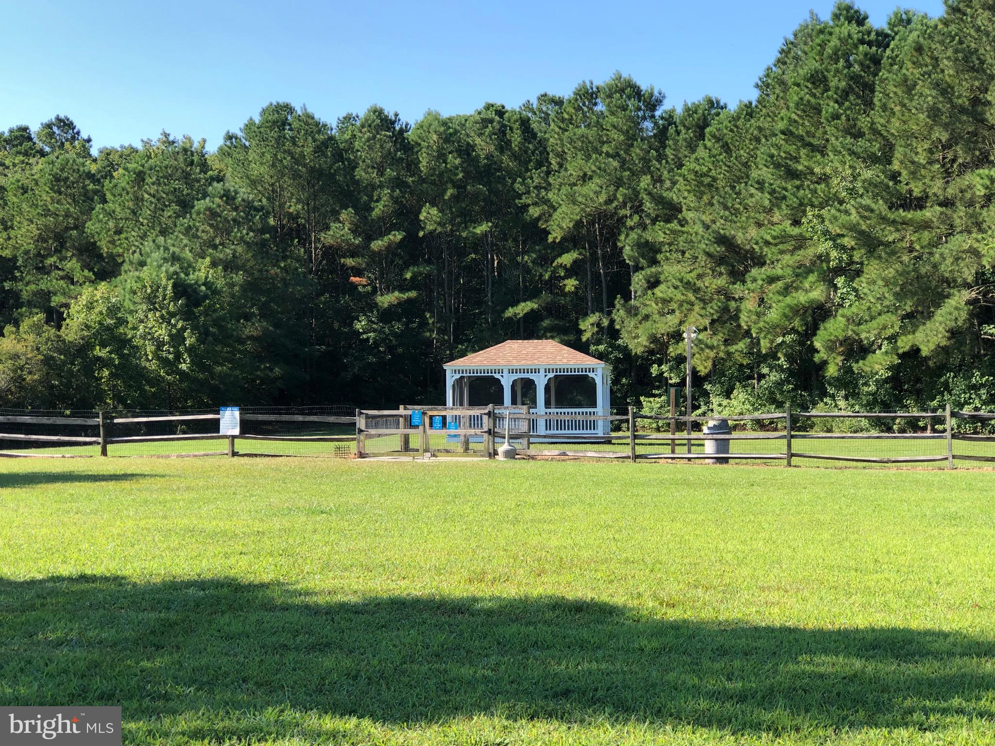 12412 Windlass Way Berlin, MD 21811 - Photo 67 of 105 a view of a swimming pool with lawn chairs under an umbrella