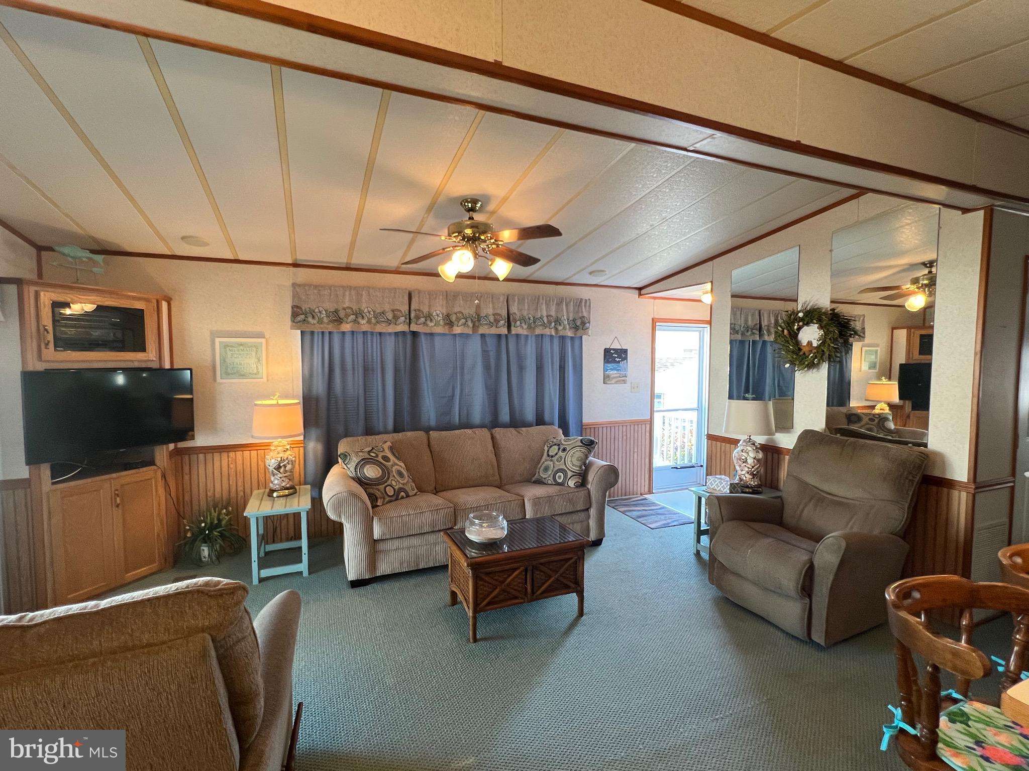 12412 Windlass Way Berlin, MD 21811 - Photo 7 of 105 a living room with furniture and a flat screen tv