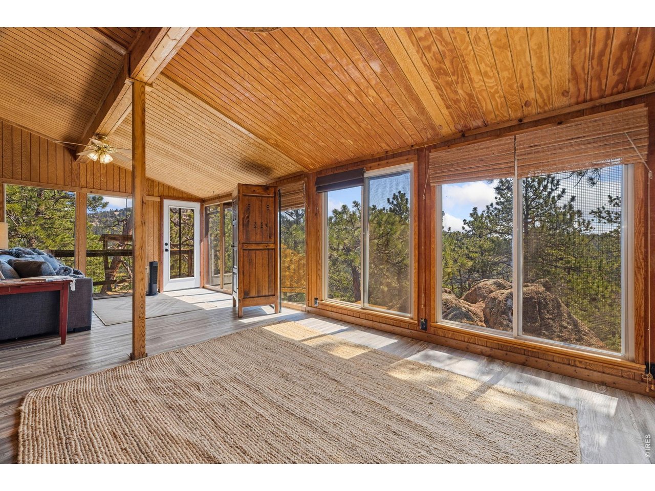 128 Elk Road Lyons, CO 80540 - Photo 13 of 50 Sunroom looking over rock outcroppings and the valley below