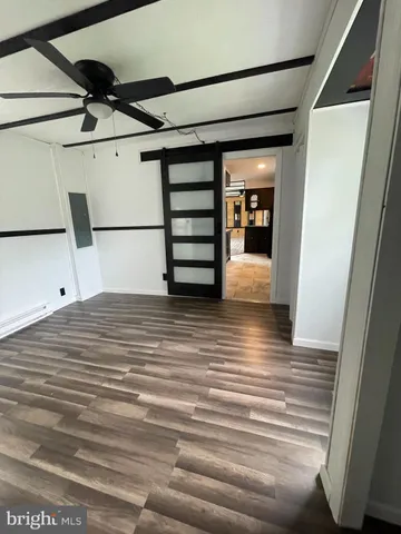 a view of a room with wooden floor and staircase