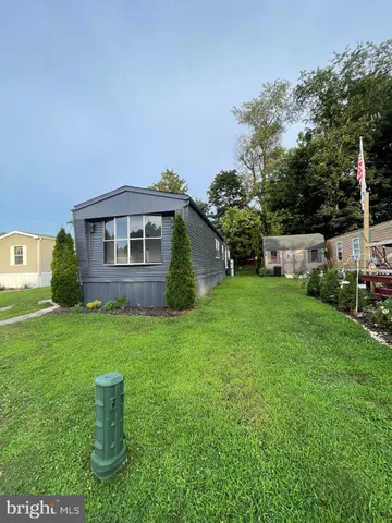 a view of a house with backyard sitting area and garden