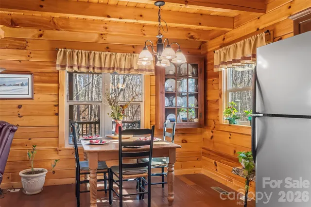 a backyard of a house with barbeque oven table and chairs