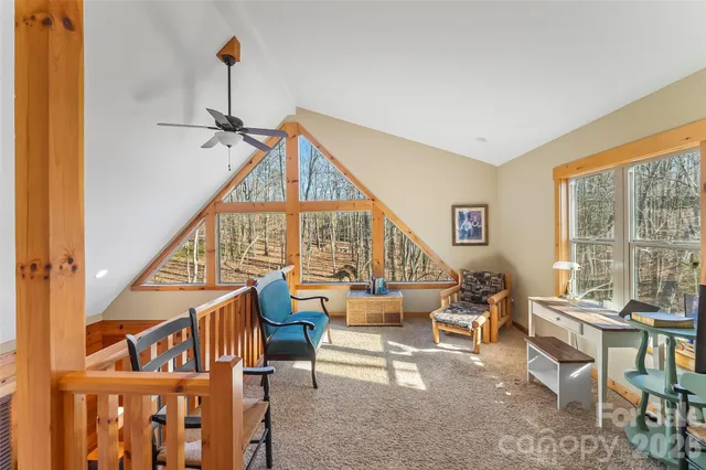 a living room with furniture a rug and a large window