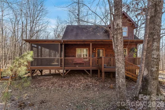 a view of a house with a yard and wooden fence