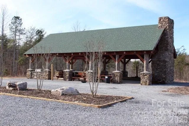 a living room with patio furniture and a fireplace