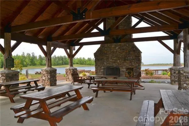 a view of a roof with wooden floor and fence