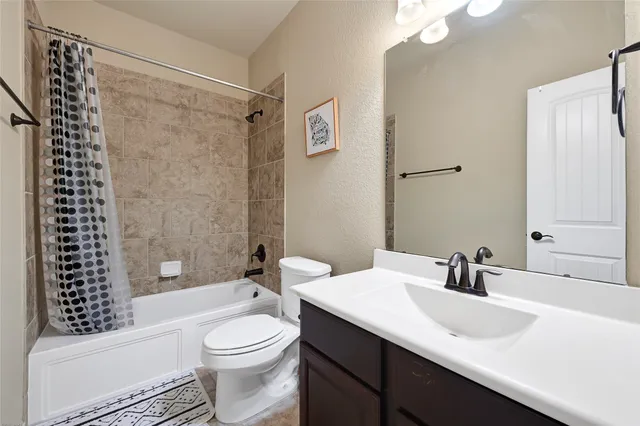 an empty room with window and ceiling fan