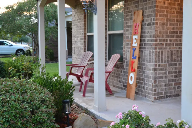 a front view of a house with a garden and yard