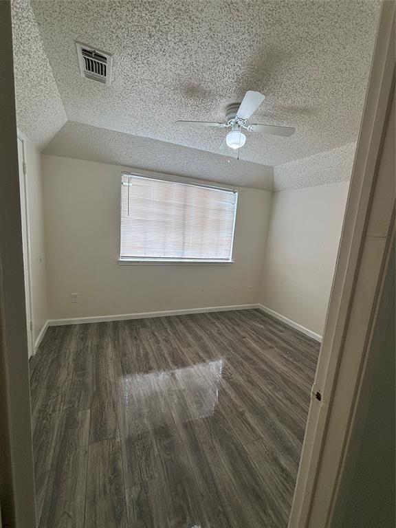 8127 Stonehurst Street, Unit 4 Dallas, TX 75217 - Photo 2 of 6 wooden floor in an empty room with a window
