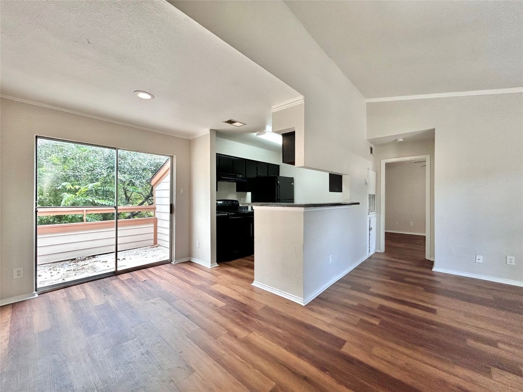 7111 East Highway 290, Unit C Austin, TX 78723 - Photo 1 of 20 a view of a kitchen with wooden floor and electronic appliances