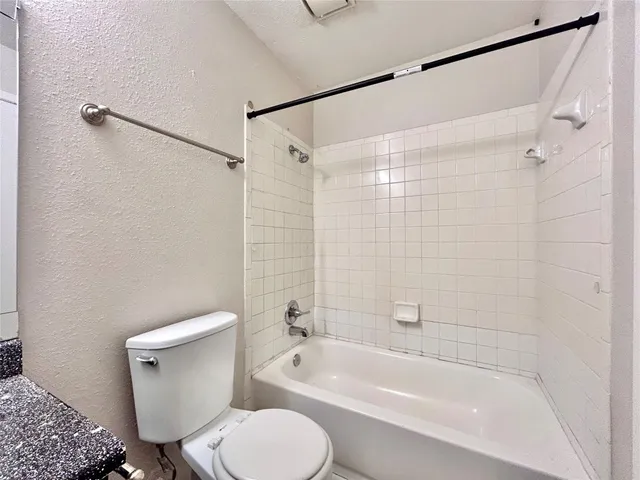a bathroom with a toilet and a bathtub