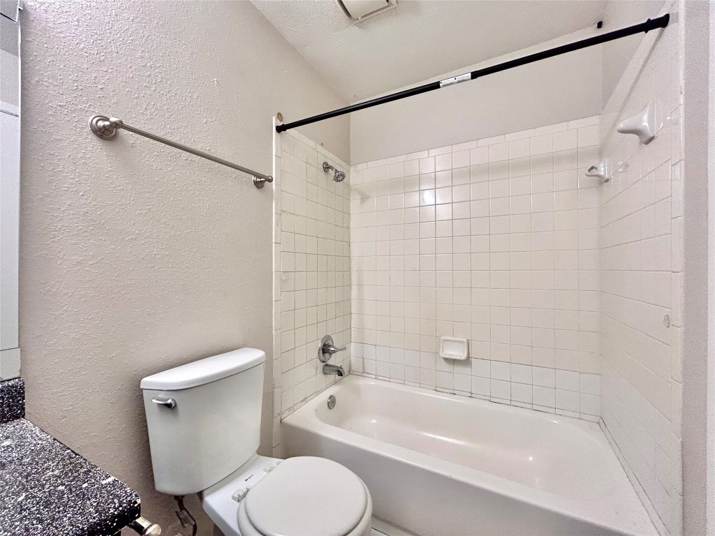 7111 East Highway 290, Unit C Austin, TX 78723 - Photo 18 of 20 a bathroom with a toilet and a bathtub