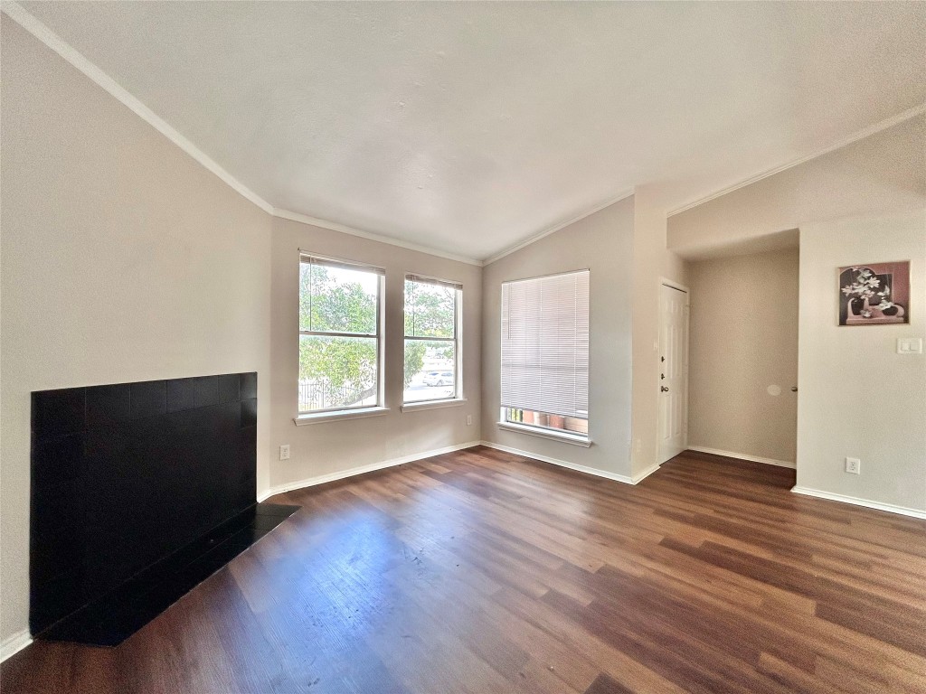 7111 East Highway 290, Unit C Austin, TX 78723 - Photo 4 of 20 an empty room with wooden floor and windows