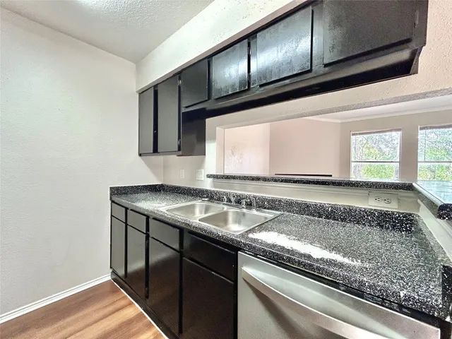 a view of a kitchen with a sink and cabinets