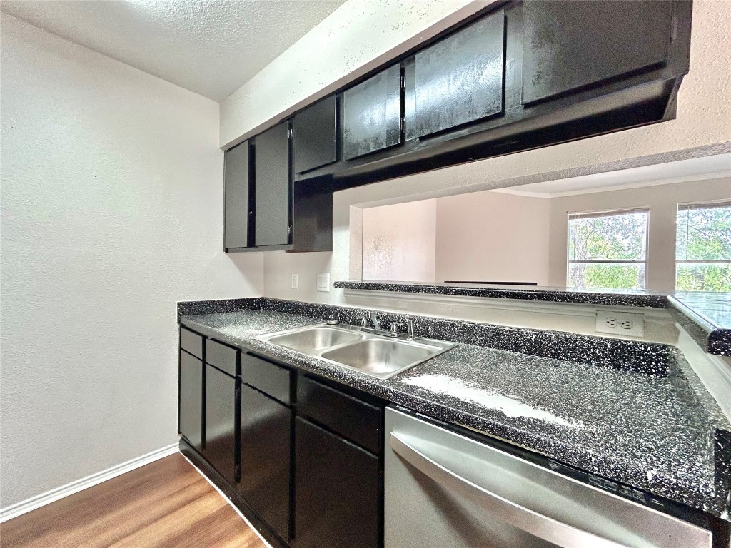 7111 East Highway 290, Unit C Austin, TX 78723 - Photo 8 of 20 a view of a kitchen with a sink and cabinets
