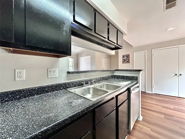 a kitchen with a sink and cabinets