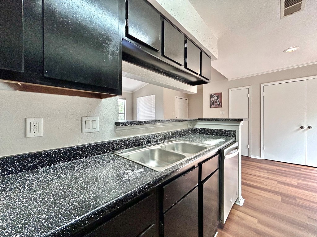 7111 East Highway 290, Unit C Austin, TX 78723 - Photo 9 of 20 a kitchen with a sink and cabinets