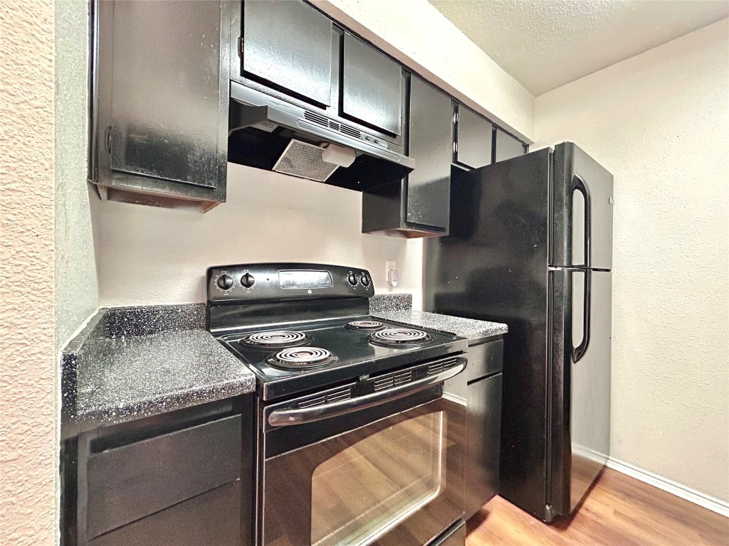 7111 East Highway 290, Unit C Austin, TX 78723 - Photo 10 of 20 a stove top oven sitting inside of a kitchen