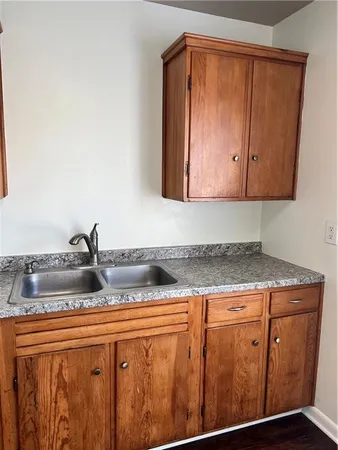 a kitchen with granite countertop cabinets and utility