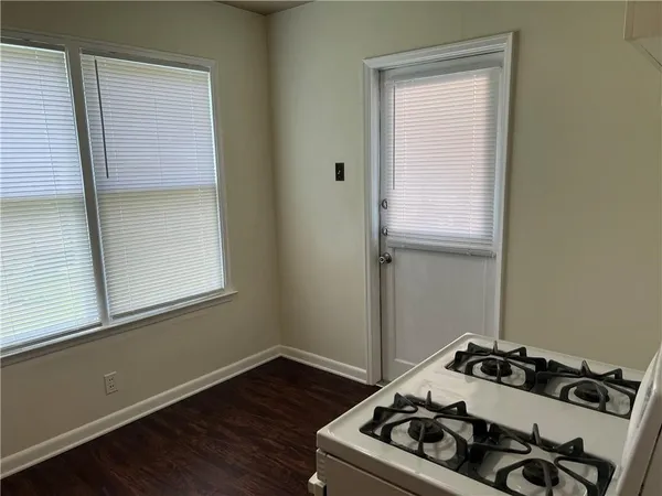 a room with a stove and wooden floor