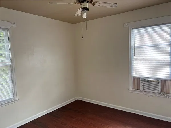 a view of a room with a window and wooden floor