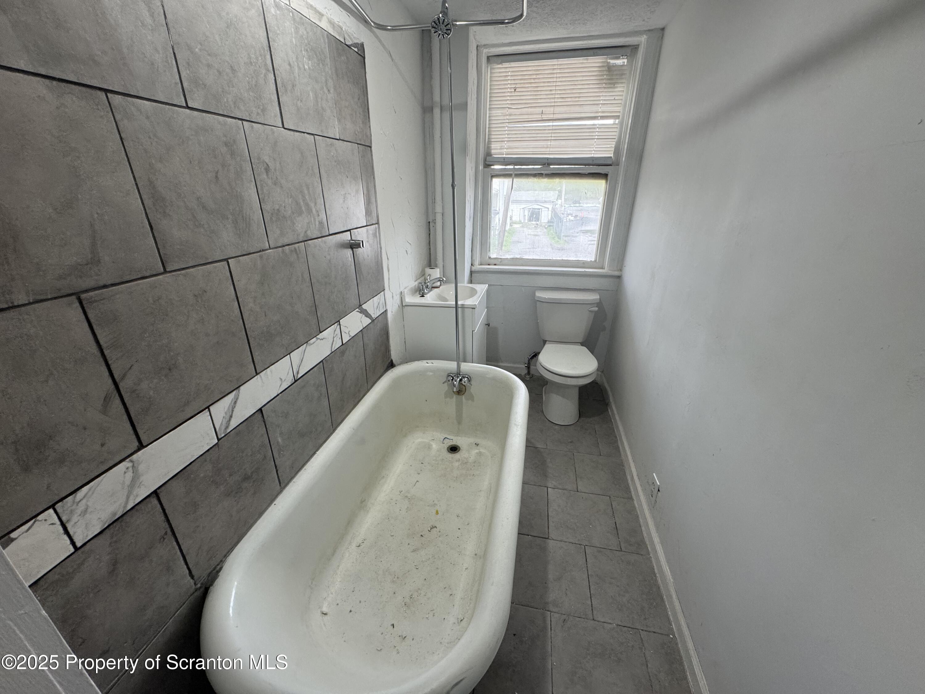 627 South Blakely Street Scranton, PA 18510 - Photo 11 of 13 a bathroom with a toilet and a bathtub