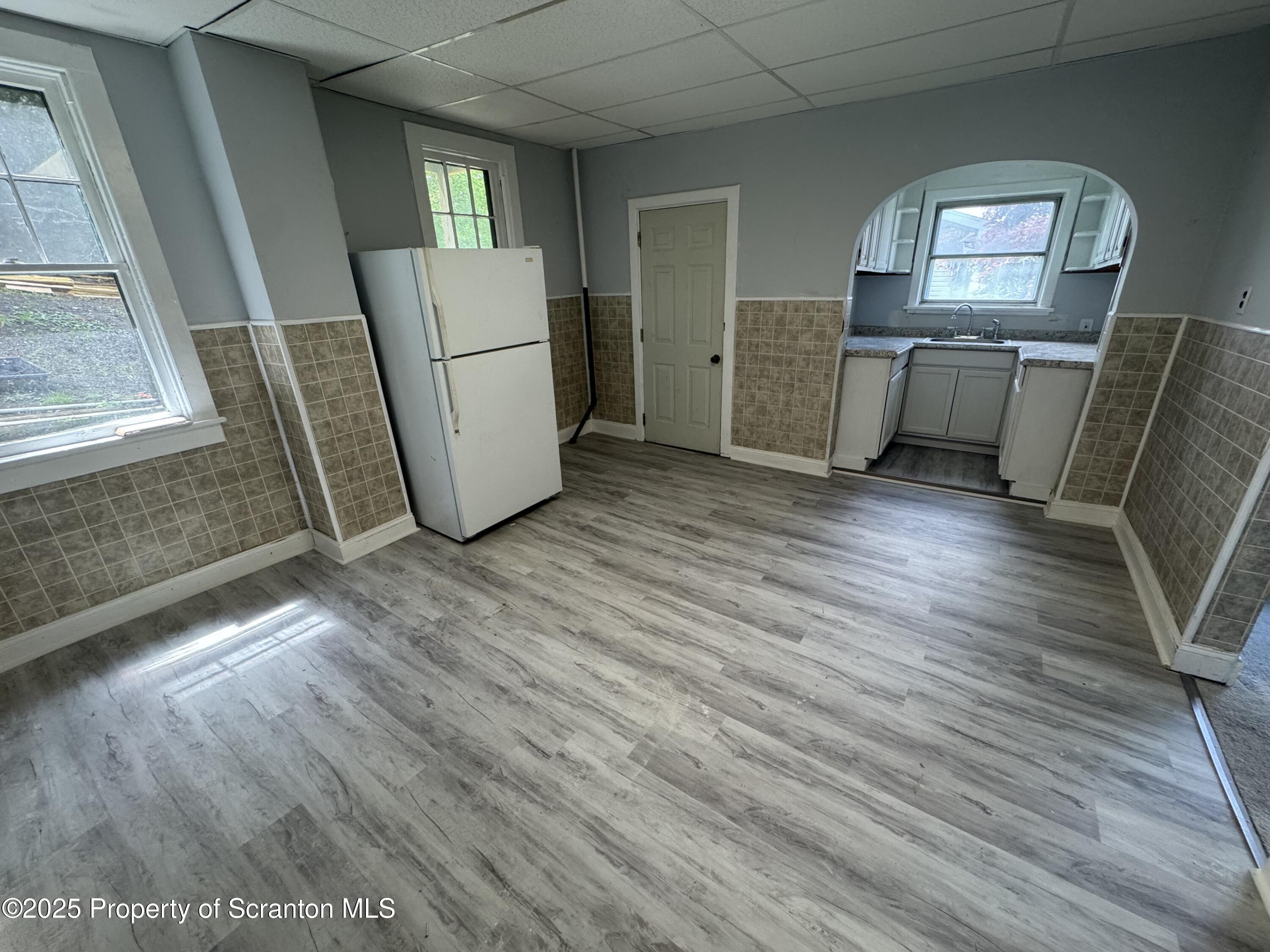 627 South Blakely Street Scranton, PA 18510 - Photo 3 of 13 a view of a kitchen with furniture and wooden floor