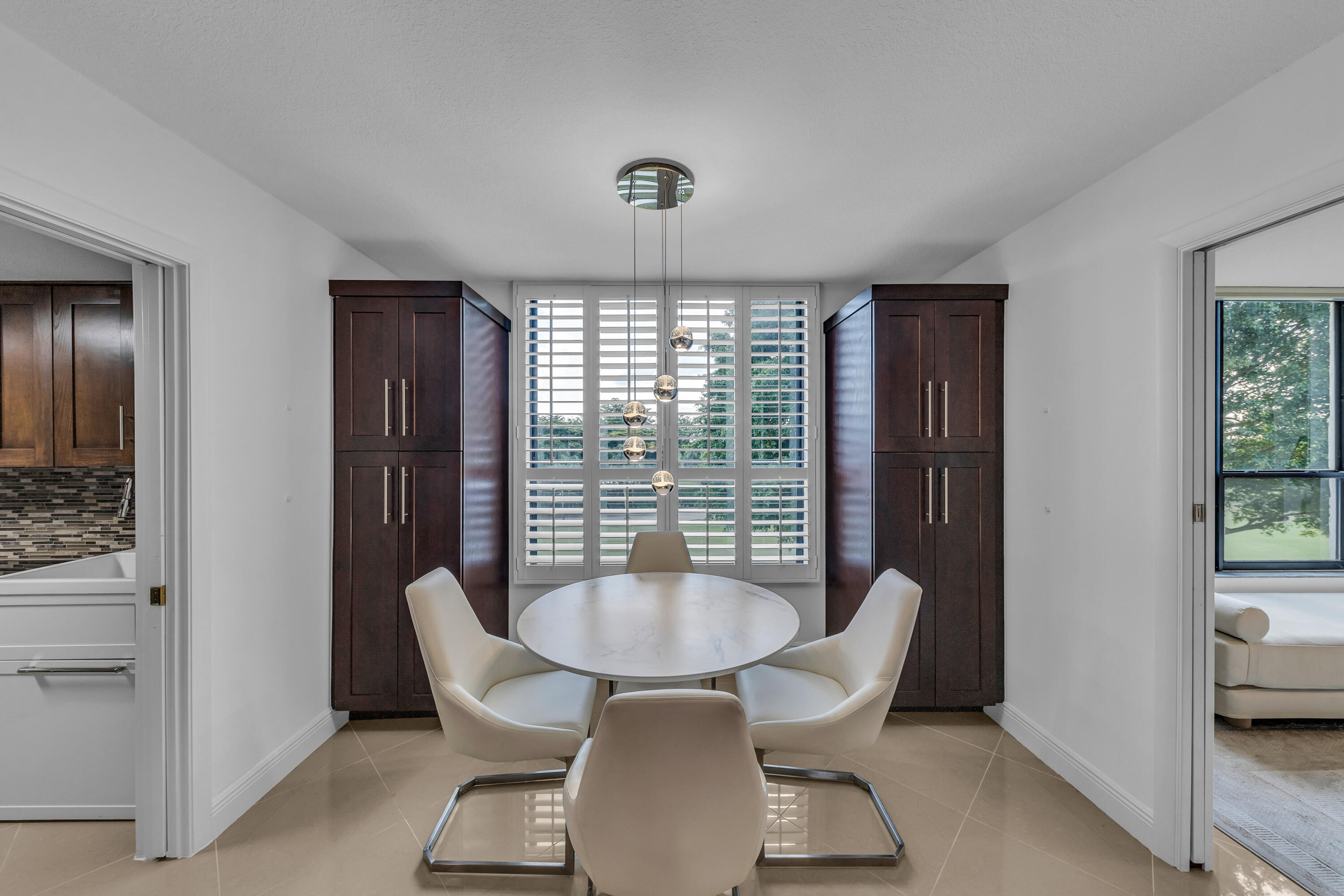 7572 Regency Lake Drive, Unit 402 Boca Raton, FL 33433 - Photo 12 of 31 a view of a dining room with furniture window and outside view