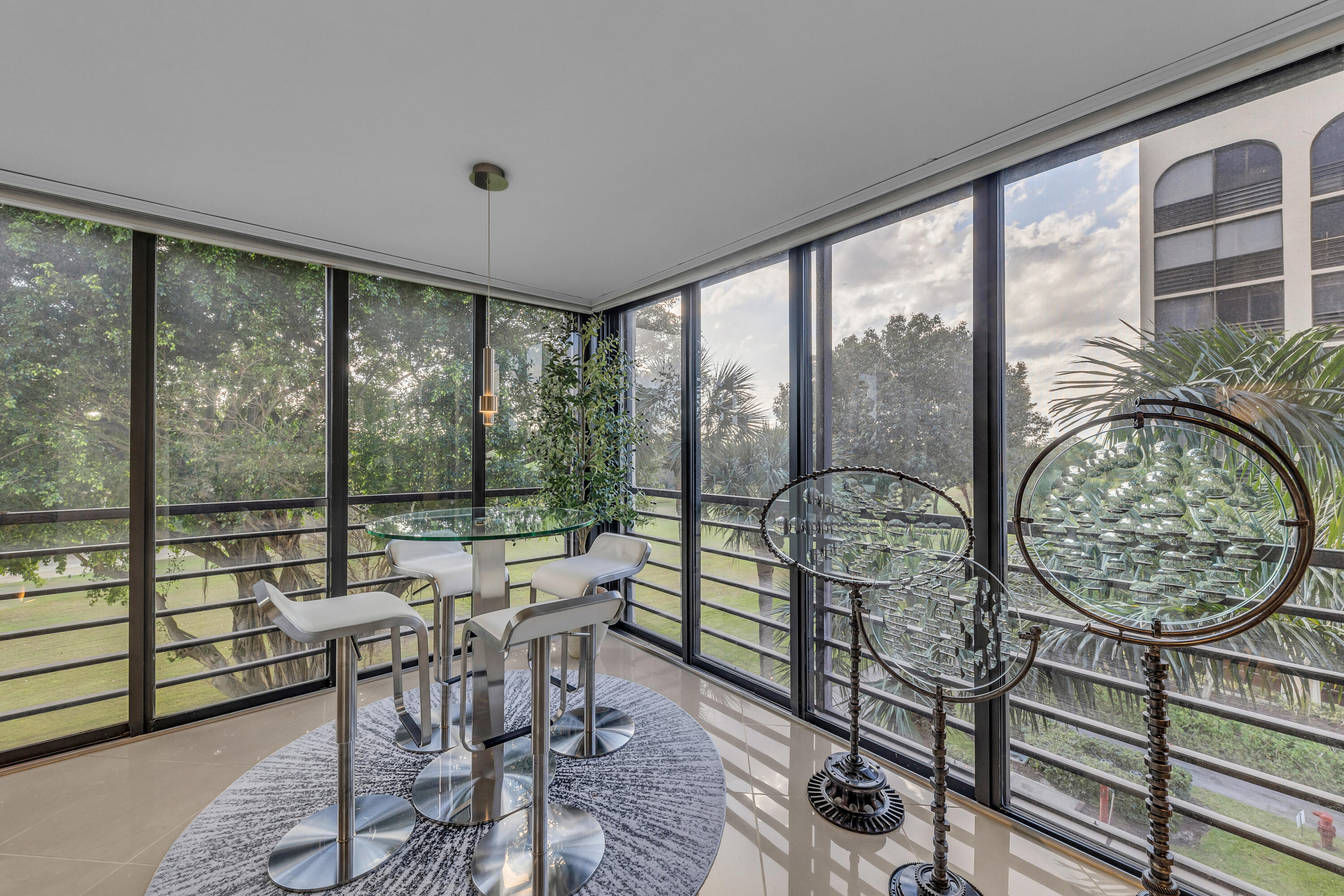 7572 Regency Lake Drive, Unit 402 Boca Raton, FL 33433 - Photo 2 of 31 a living room with furniture and a floor to ceiling window