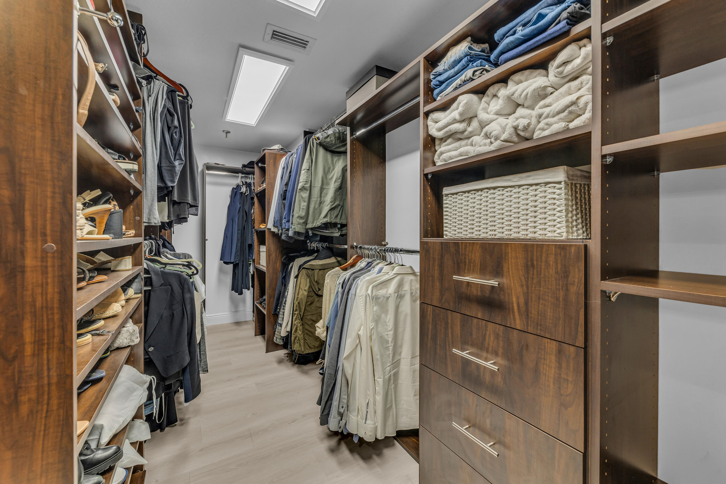 7572 Regency Lake Drive, Unit 402 Boca Raton, FL 33433 - Photo 24 of 31 a view of walk in closet with clothes and shoes