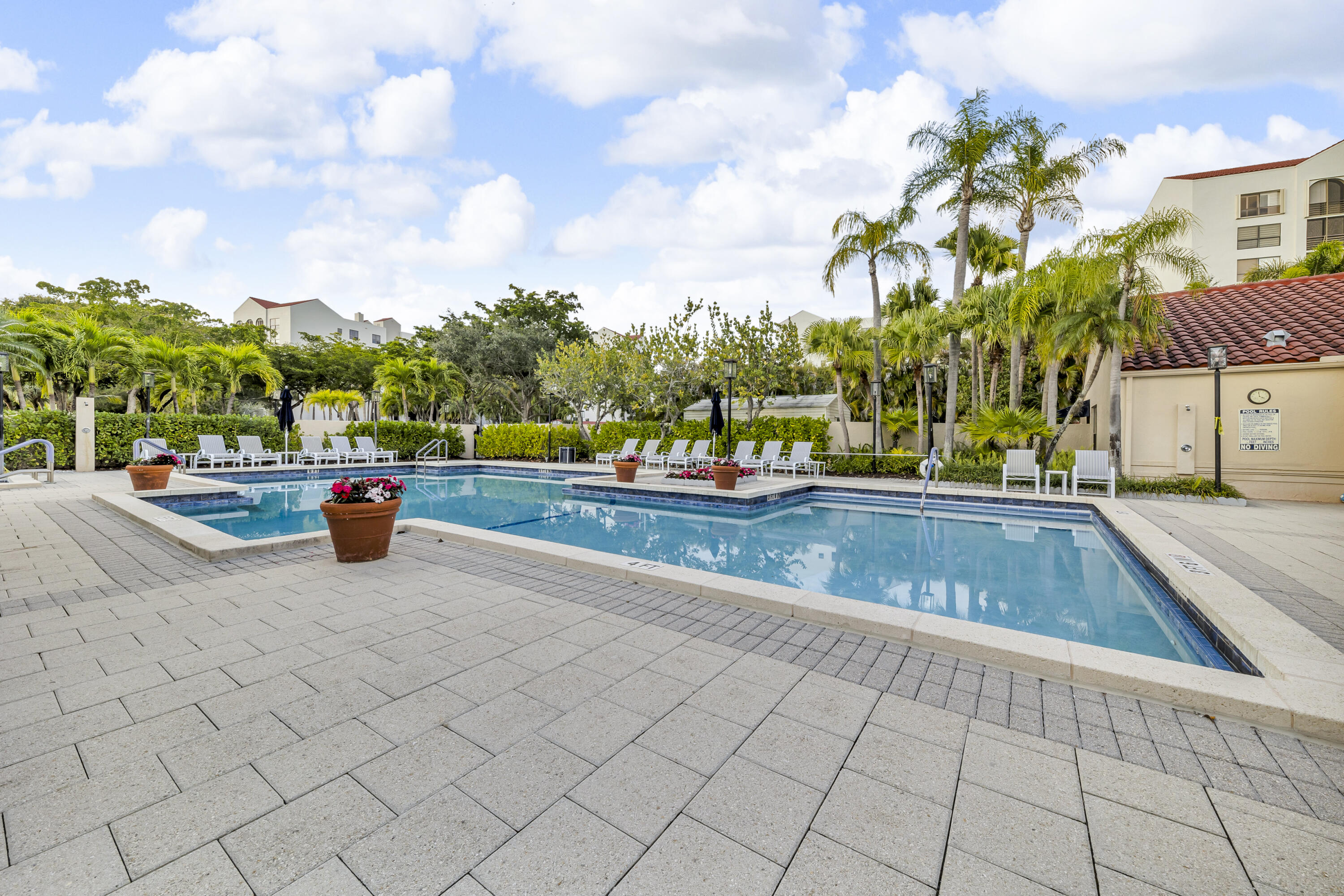 7572 Regency Lake Drive, Unit 402 Boca Raton, FL 33433 - Photo 29 of 31 a view of an outdoor space and swimming pool